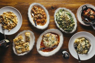 overhead photo of a variety of pasta dishes and appetizer offerings