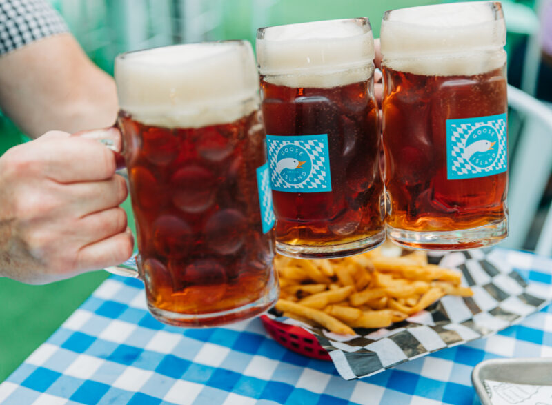 Three beer steins and fries