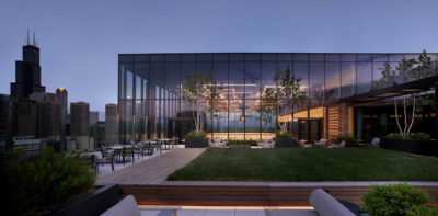 Exterior shot of the event space showing floor to ceiling windows with views of the Willis Tower in the background.
