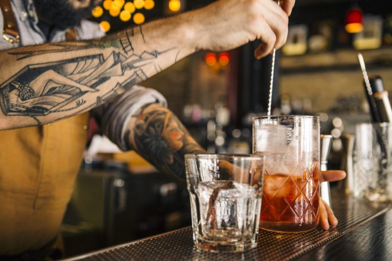 Bartender mixing a Negroni