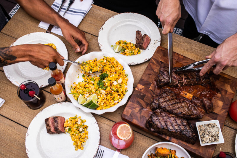 Enjoying the BBQ overhead shot of steak and corn salad