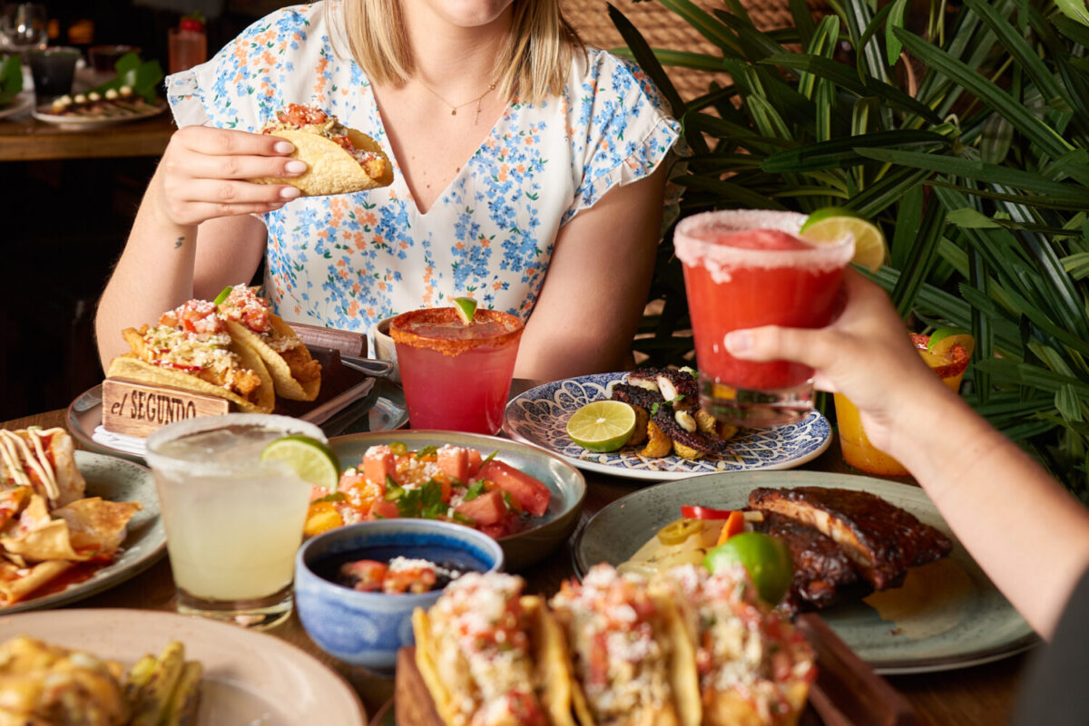 Two people having drinks and food at El Segundo Sol