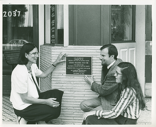 02 Studio Building dedication, 1982 _ Tecoah Bruce with plaque and two other people.png