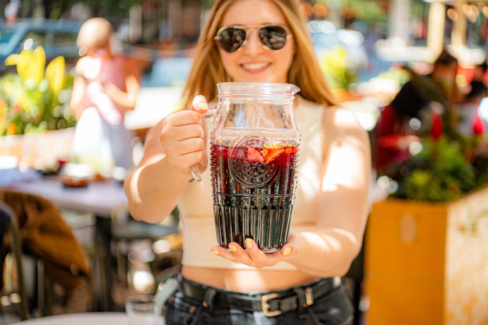 Girl holding a pitcher of sangria on Lil' Ba-Ba-Reeba!'s patio