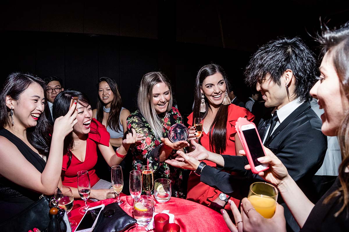 Sydney corporate magician Junho performing magic at a cocktail event