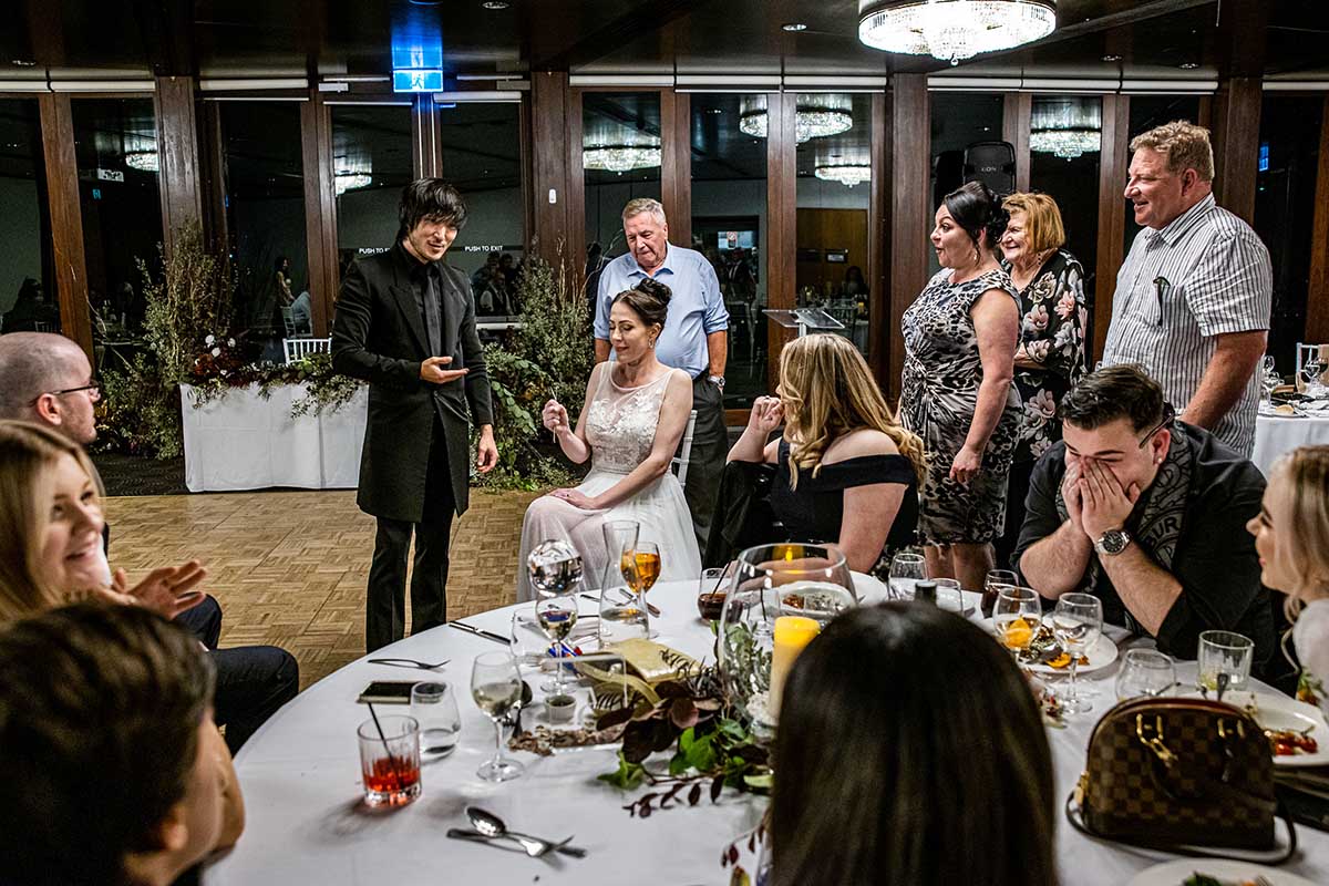Magician Sydney Junho performing for bride at wedding