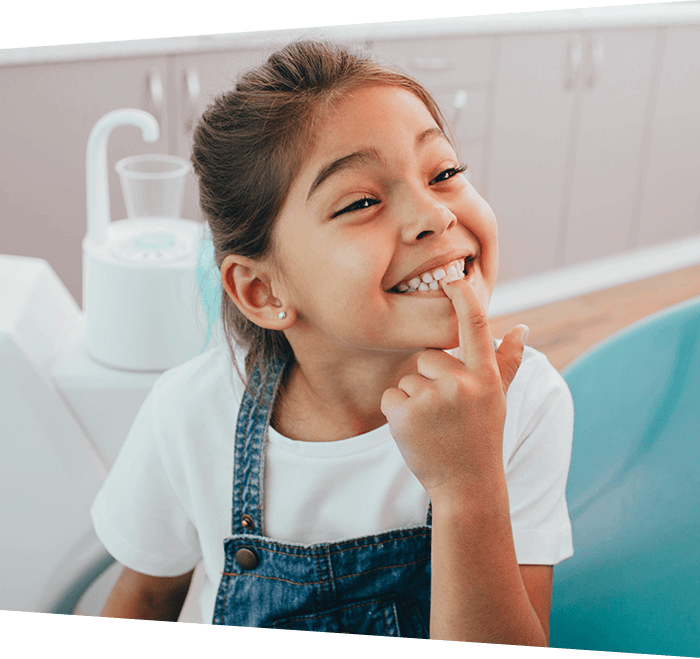 Smiling child showing teeth