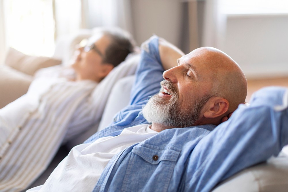 Man on couch wearing comfortable dentures