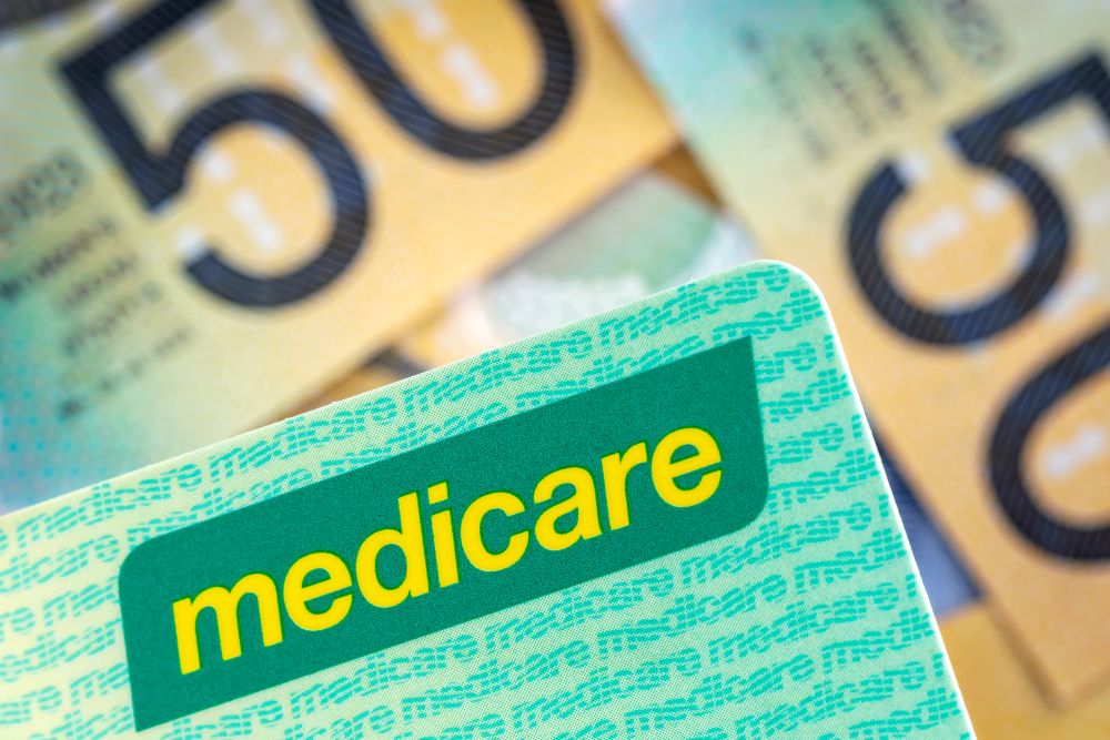 Medicare card with Australian fifty dollar notes