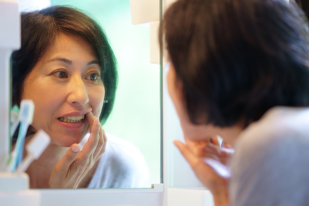 Woman looking at uppder denture