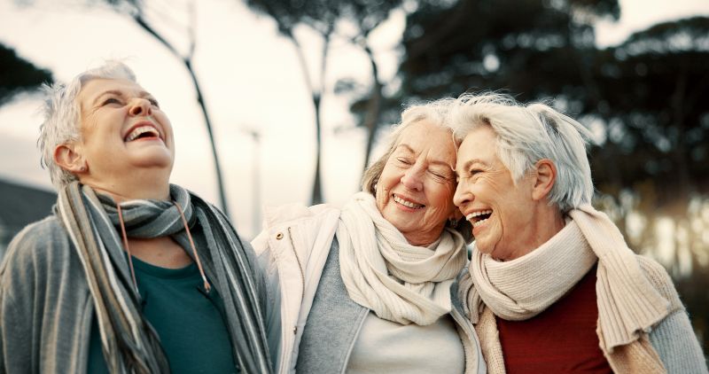 Women pensioners laughing with dentures