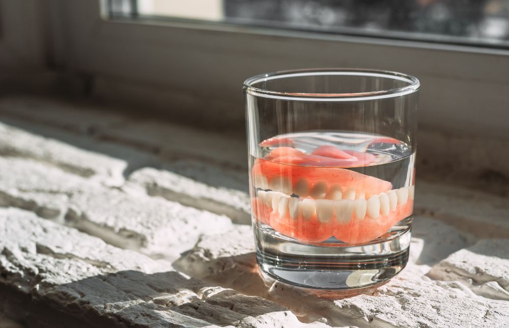 What should I soak my dentures in at night