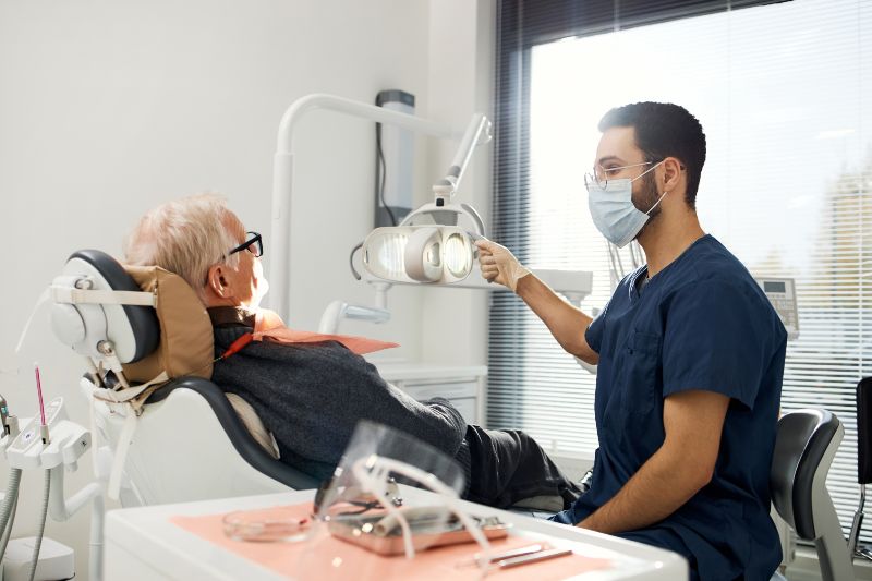 Patient with loose dentures in dental chair