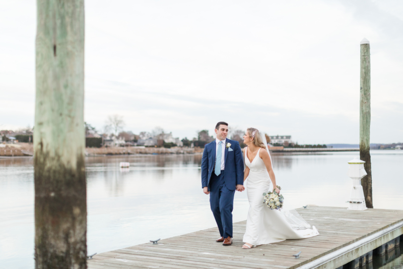 couple on dock during their wedding at Oyster Point Hotel in Red Bank