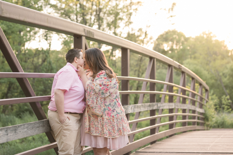 couple kissing on a bridge at Colonial Park during their engagement