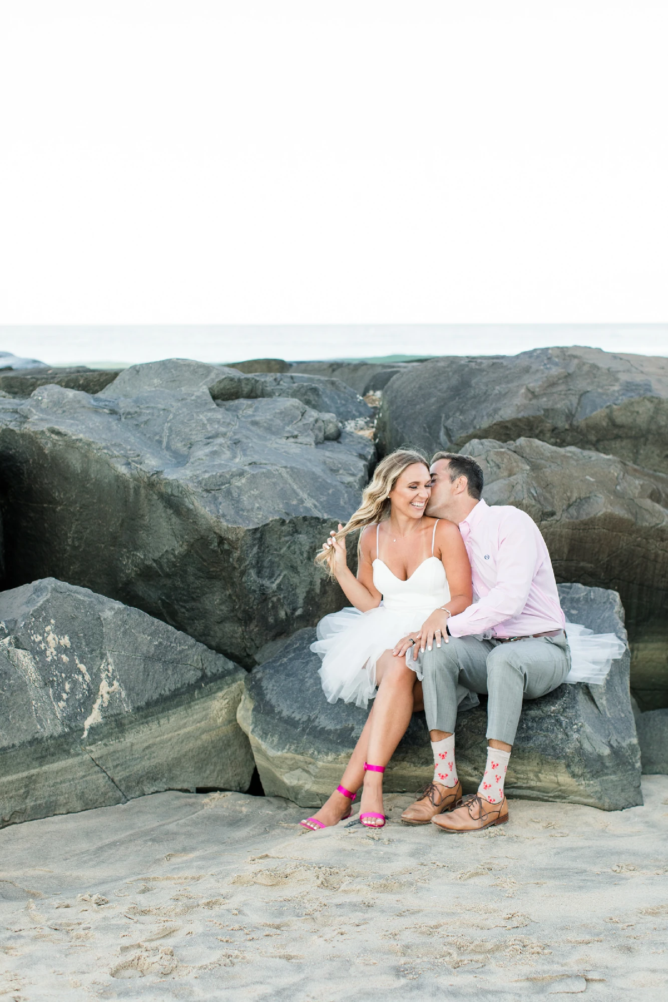 Bride and Groom siting on the Rock near Beach in New Jersey