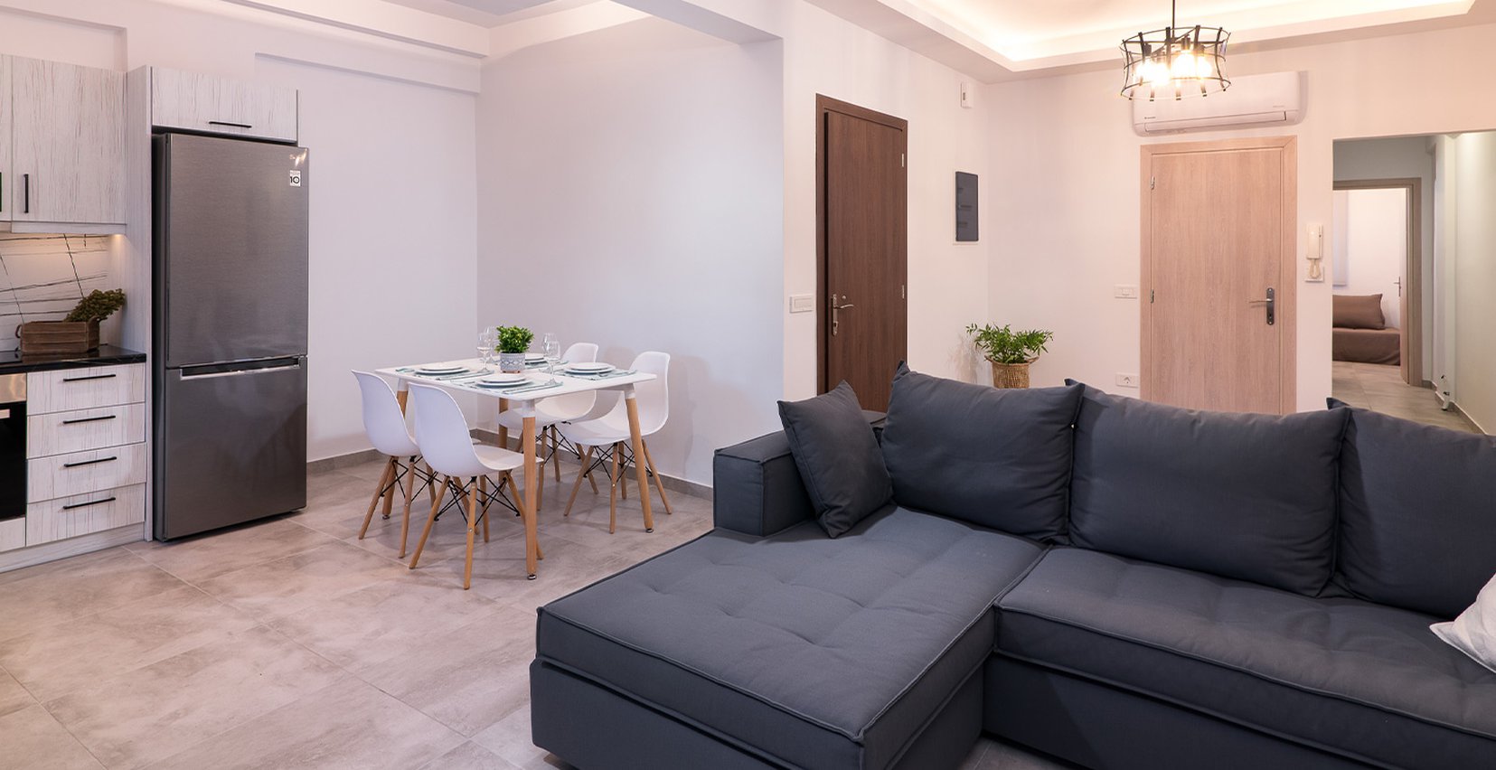 Το σαλόνι του Deluxe Apartment του Lithies Zante Living. Διαμέρισμα με μεγάλο καναπέ μοντέρνα διακόσμηση και μπαλκόνι.