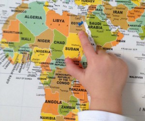 Child pointing on map on Africa