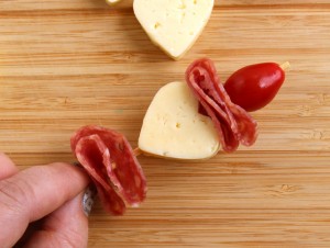 Valentine's Day Bento assembling cheese heart, salami and cherry tomato kabob