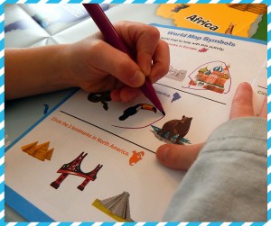 Review for Early Explorers Photo Child Circling Toucan in Activity Book