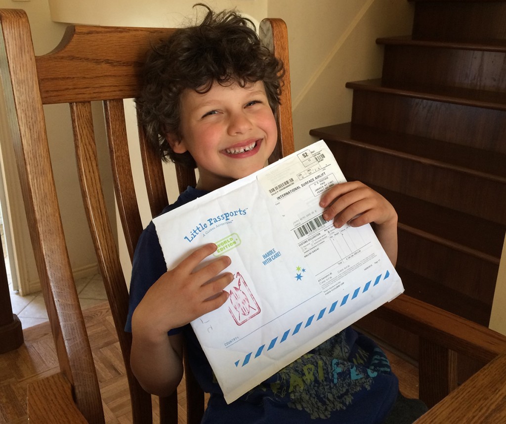 Little Passports Blog Noah holding World Edition Envelope Kenya