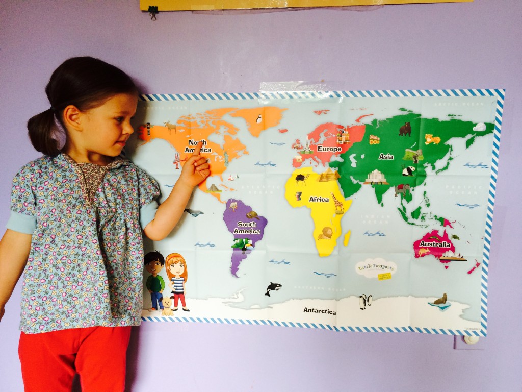 Little Passports Blog 5 Reasons Why Your Preschooler will love Early Explorers Girl Posing with World Map