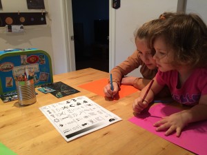 Two girls playing with Little Passports World Edition Australia Scratch Kit