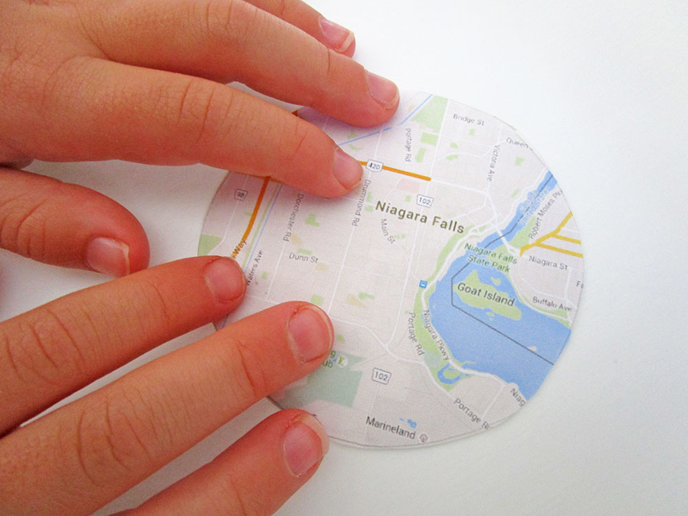 Little Passports Blog DIY Map Craft Pasting Map onto Cardboard