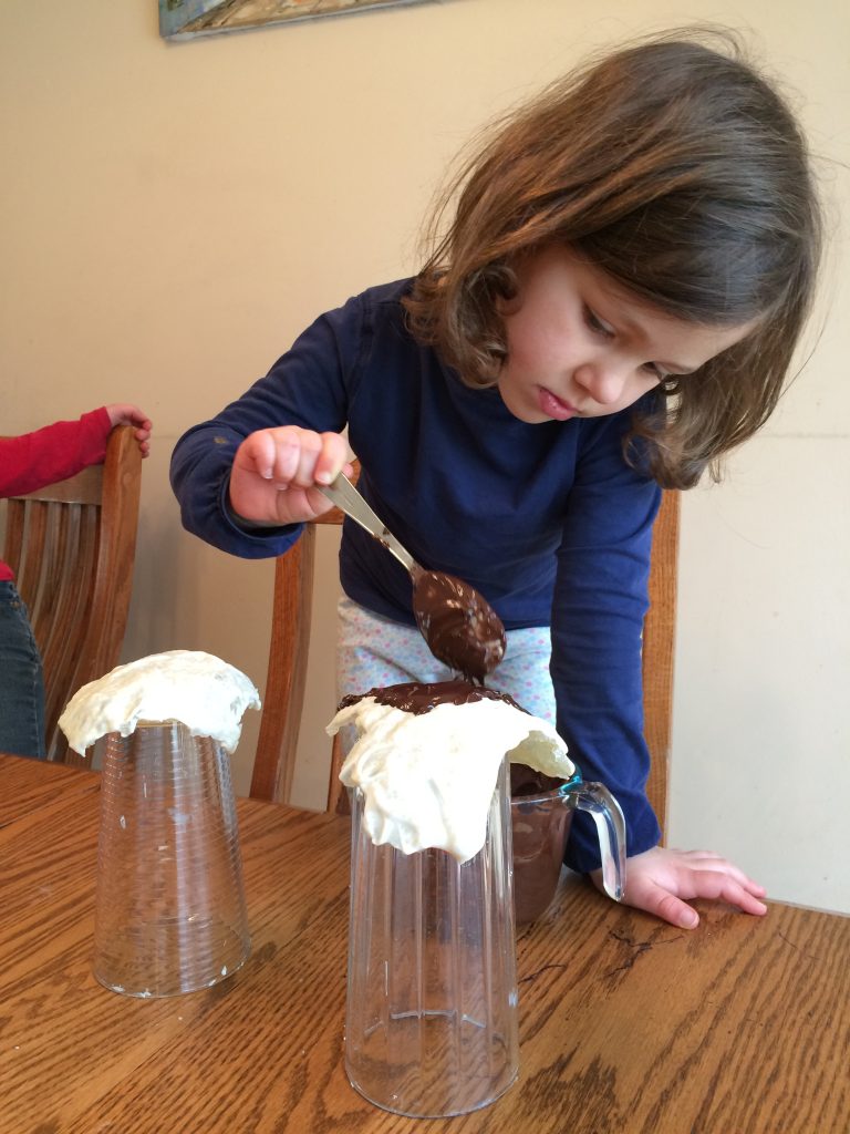 Girl placing melted chocolate over edible geode