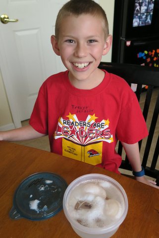 Boy smiling with egg experiment