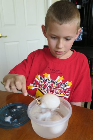 boy taking egg out of container