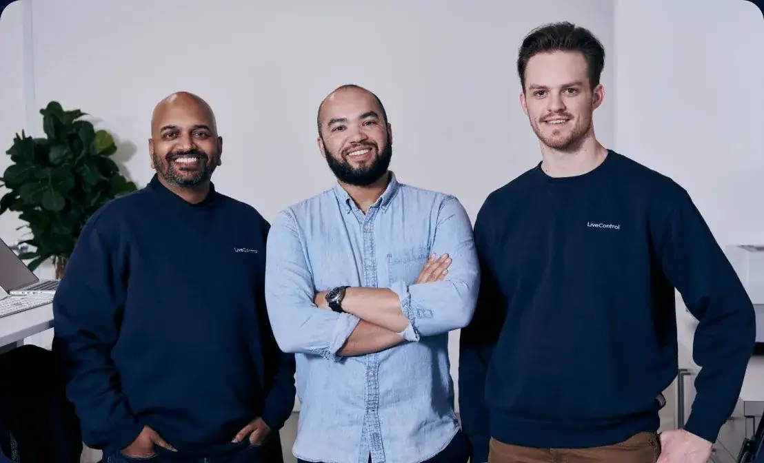 Three LiveControl employees posing in LiveControl gear