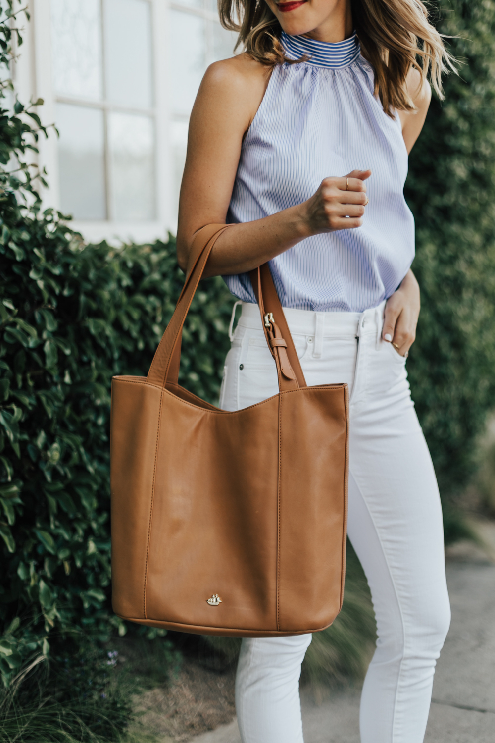 https://storage.googleapis.com/livvyland/2017/07/livvyland-blog-olivia-watson-brahmin-brayden-tan-charleston-tote-j-crew-halter-back-tie-top-classic-outfit-3.jpg