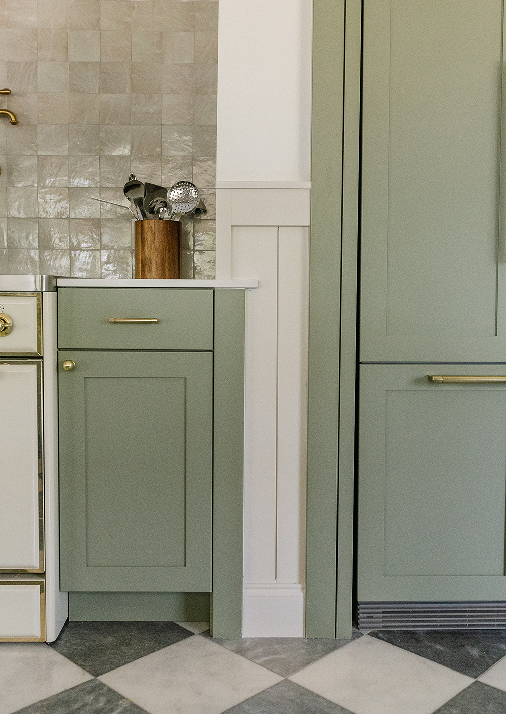 https://storage.googleapis.com/livvyland/2022/07/livvyland-blog-kitchen-cozy-french-country-cottage-diamond-tile-marble-floor-green-cabinets-silestone-el-statuario-quartz-countertops-ilve-majestic-range-verticle-shiplap-half-wall.jpg