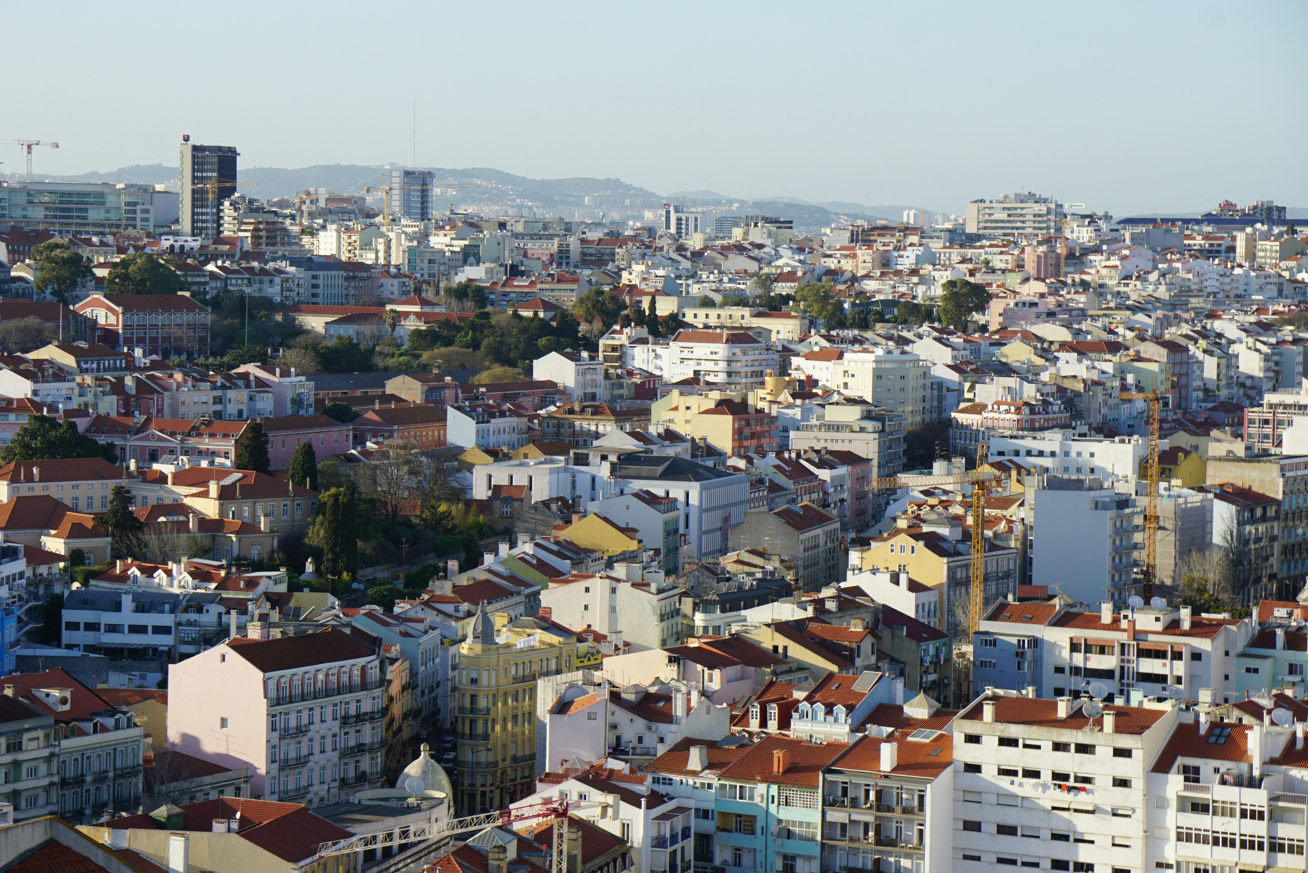 A charming street in Lisbon lined with colorful buildings, traditional Portuguese tiles, and narrow cobblestone paths, capturing the city’s unique architecture and everyday life.