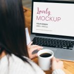 This Mockup Of A Woman Working on Her Macbook While Drinking Coffee is perfect for designers, and agencies to be used in marketing, and sales campaigns.