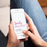 White iPhone Mockup in Woman's Hands While Browsing The Internet