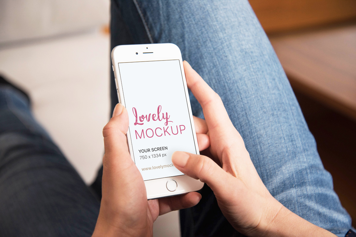 Download White iPhone Mockup in Woman's Hands While Browsing The Internet - Lovely Mockups