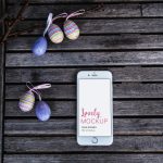 White iPhone Mockup With Easter Eggs on An Old Bench