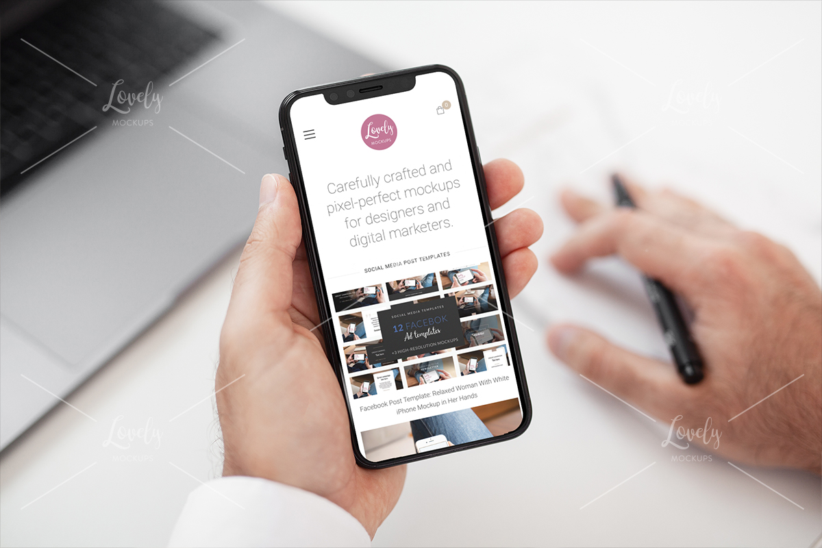 Download Mockup Of A Man Holding An Iphone 11 While Working Lovely Mockups