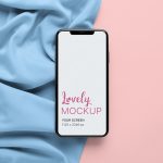 iPhone Mockup Featuring a Colored Fabrics Setting Featured