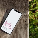 iPhone Mockup Lying on a Wooden Bench Outdoors Featured