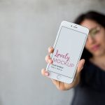 Mockup of a Woman Holding a Silver iPhone 8 Plus Featured