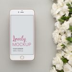 Gold iPhone Mockup Lying Next to White Flowers Featured