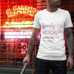 Mockup of a Man Wearing a T-Shirt with Neon Signs featured