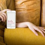 Mockup of an iPhone with a Blonde Woman on a Sofa featured