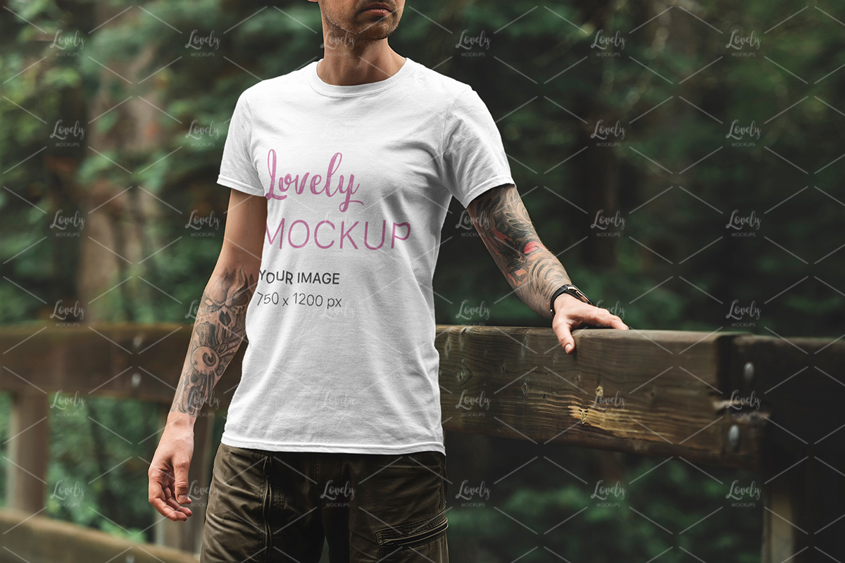 Download T Shirt Mockup Of A Man Standing On A Bridge Lovely Mockups
