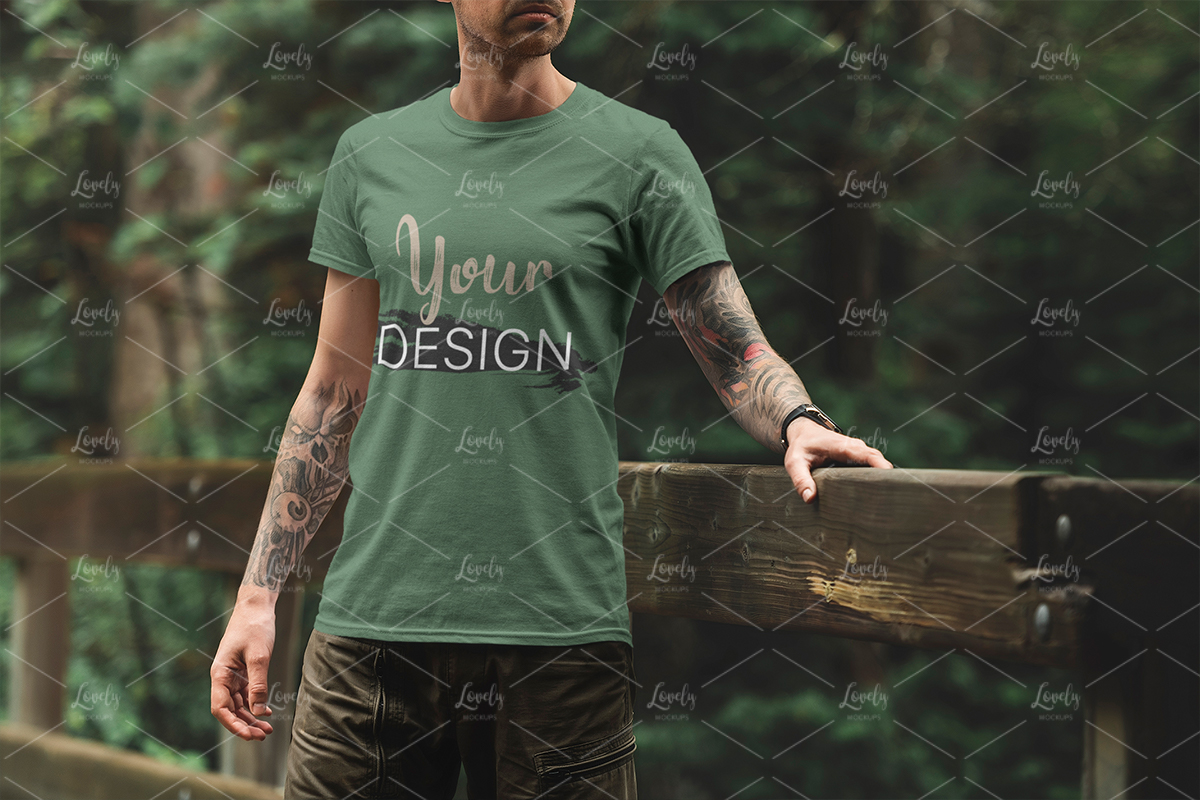 Download T Shirt Mockup Of A Man Standing On A Bridge Lovely Mockups