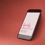 Space Gray iPhone Mockup Angled Over a Solid Surface Featured