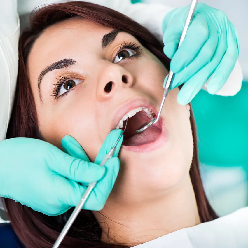 Patient getting his teeth check for cavities at Gardena Dental Group